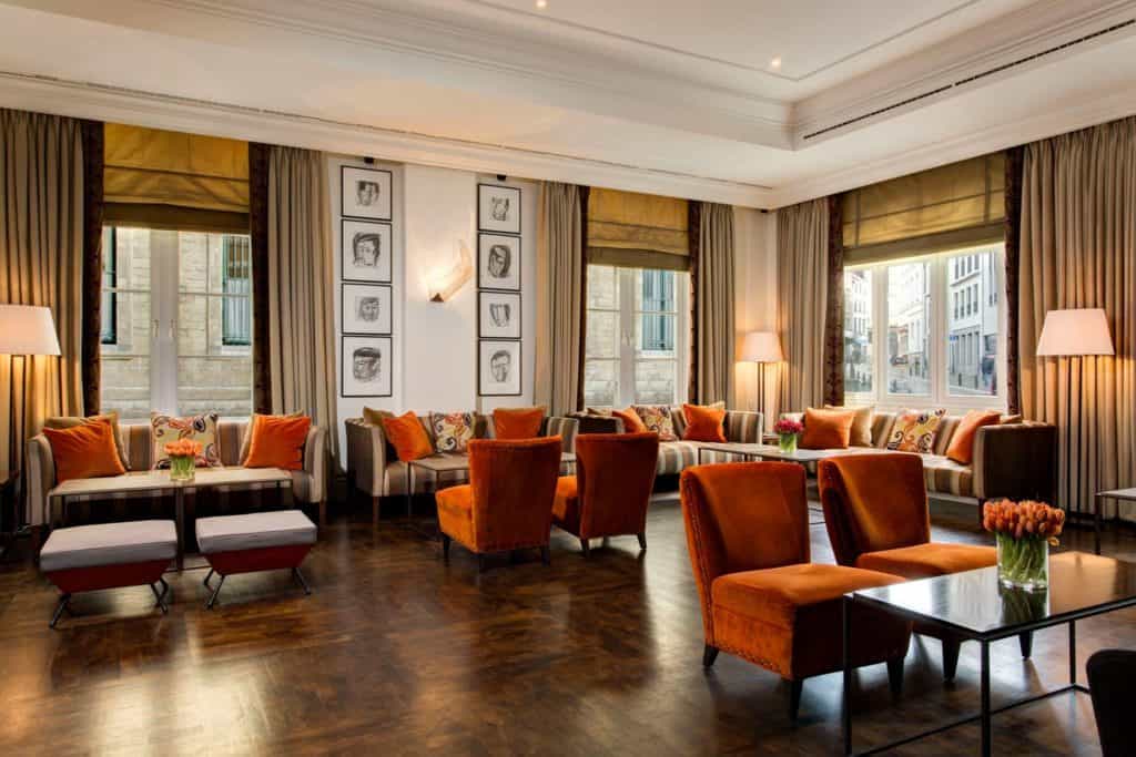 High-end restaurant with dark orange accent colour and parquet flooring