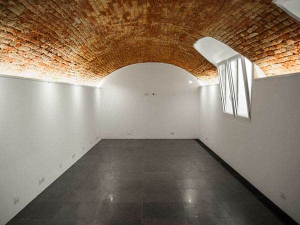 Clean white space with historical vaulted brick ceiling