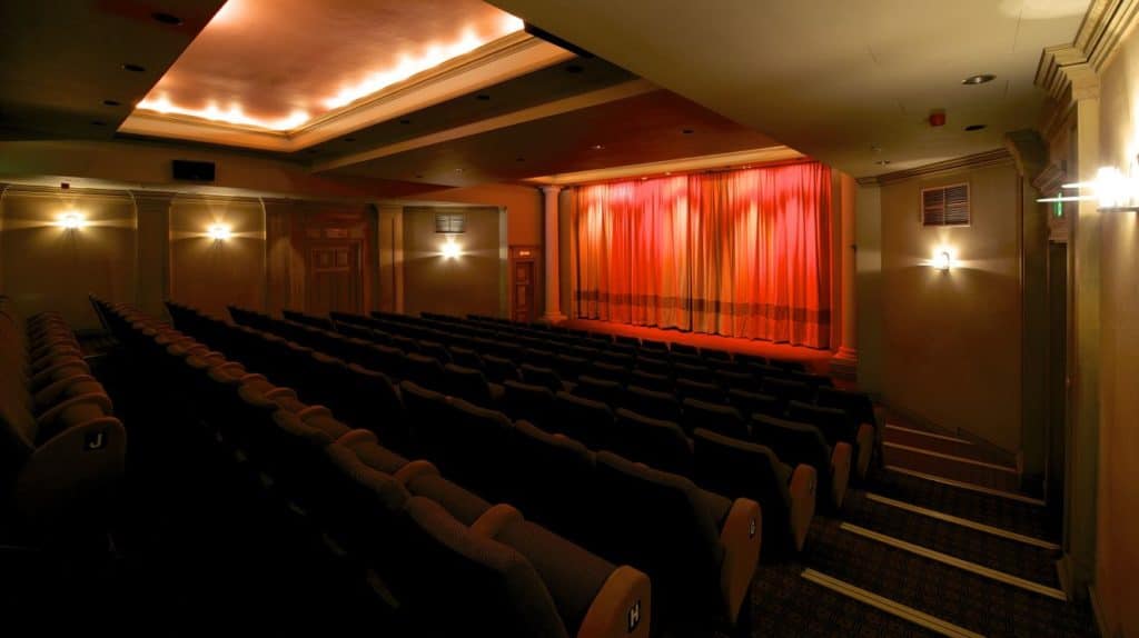 Distinctive auditorium with an elegant character featuring 144 comfortable seats, beautiful drapes and period pillars.
