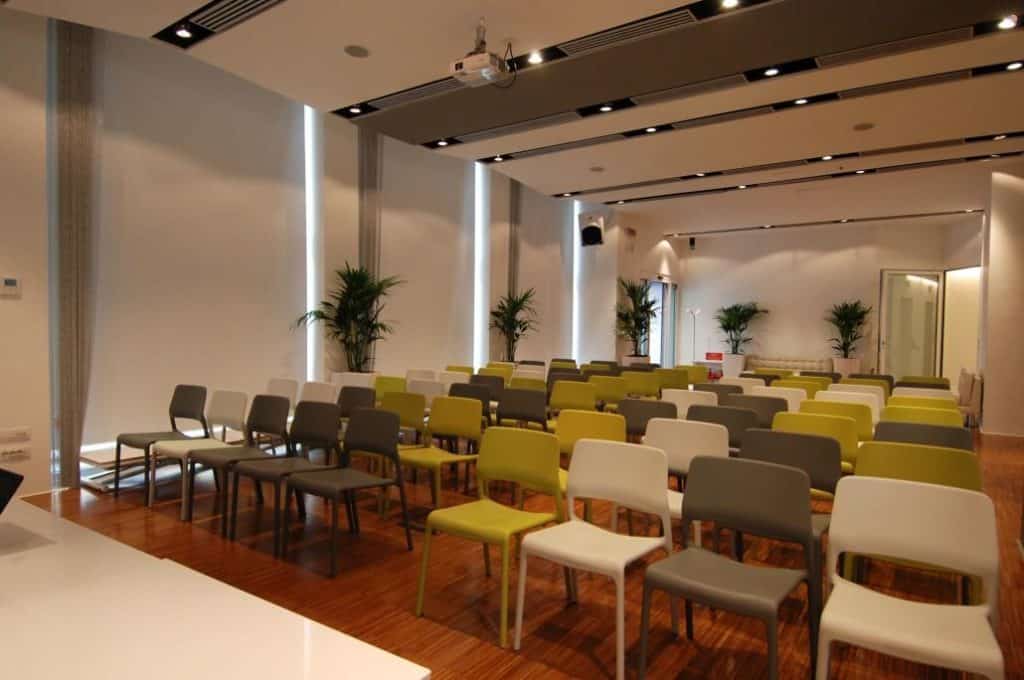 Luminous event space with a modern look featuring high ceilings and polished wooden floors.