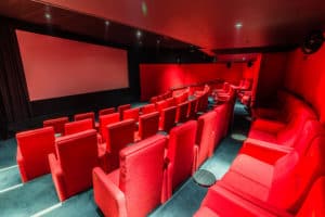 Quirky screening room painted in red with top-of-the-range technology and 69 seats.