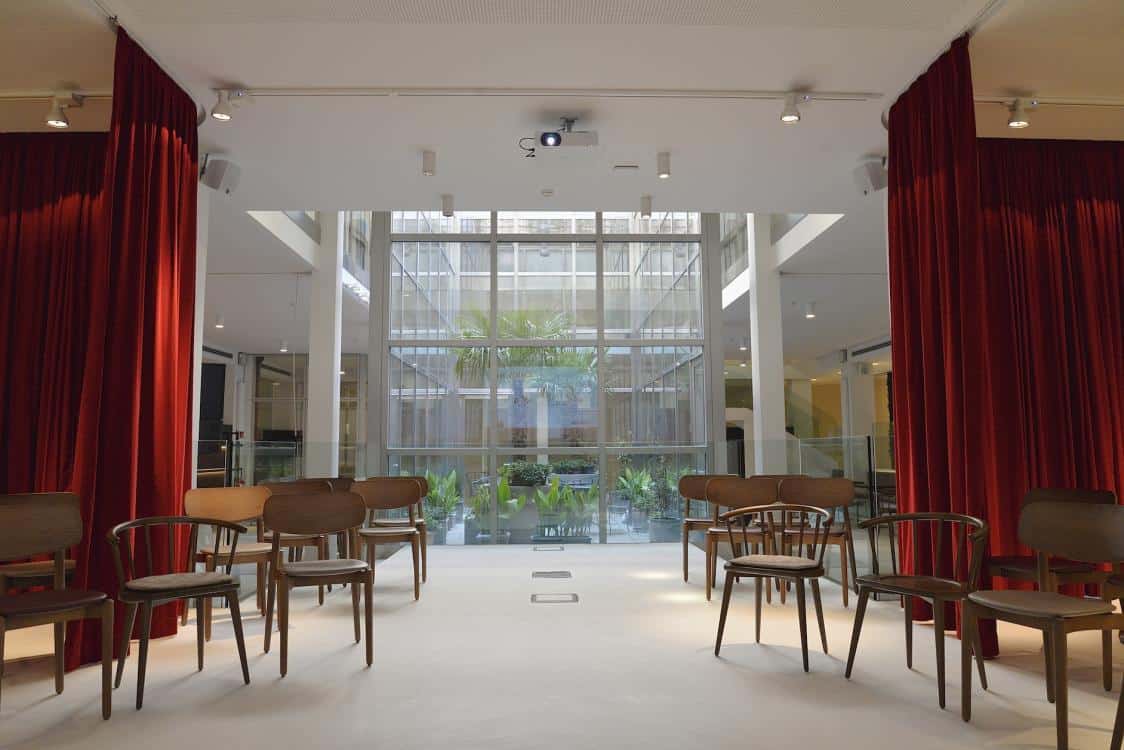 Spectacular bright venue bathed in natural light featuring a sleek and modern design with high ceilings.