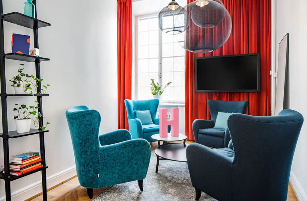 Meeting room with lounge chairs and bright red and blue colours