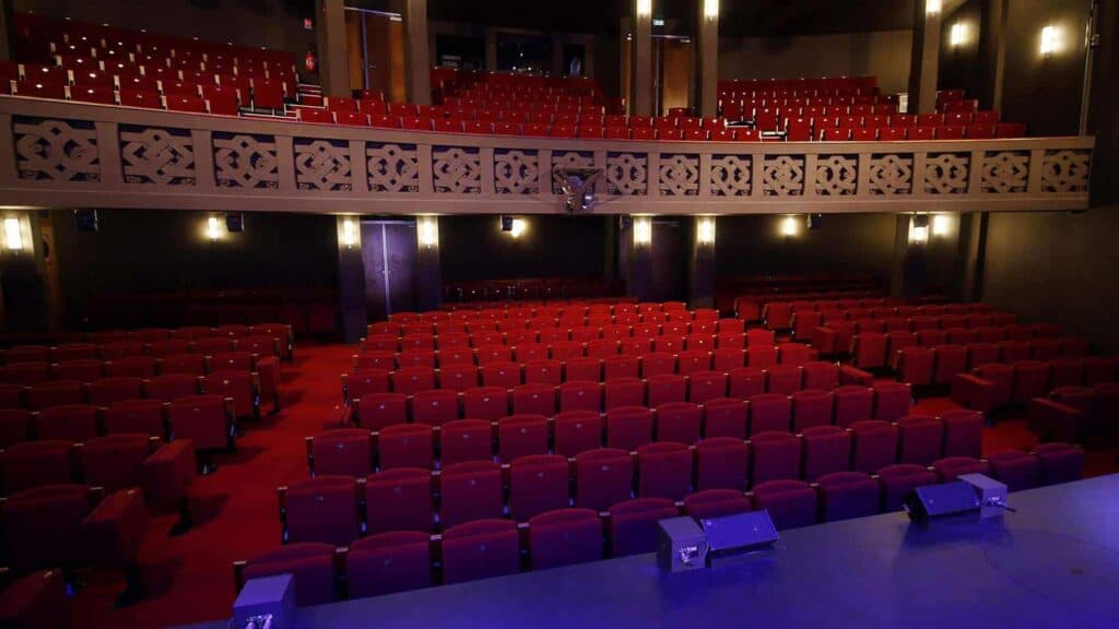 Opulent Parisian auditorium for remarkable events with cosy lighting and comfortable seating.